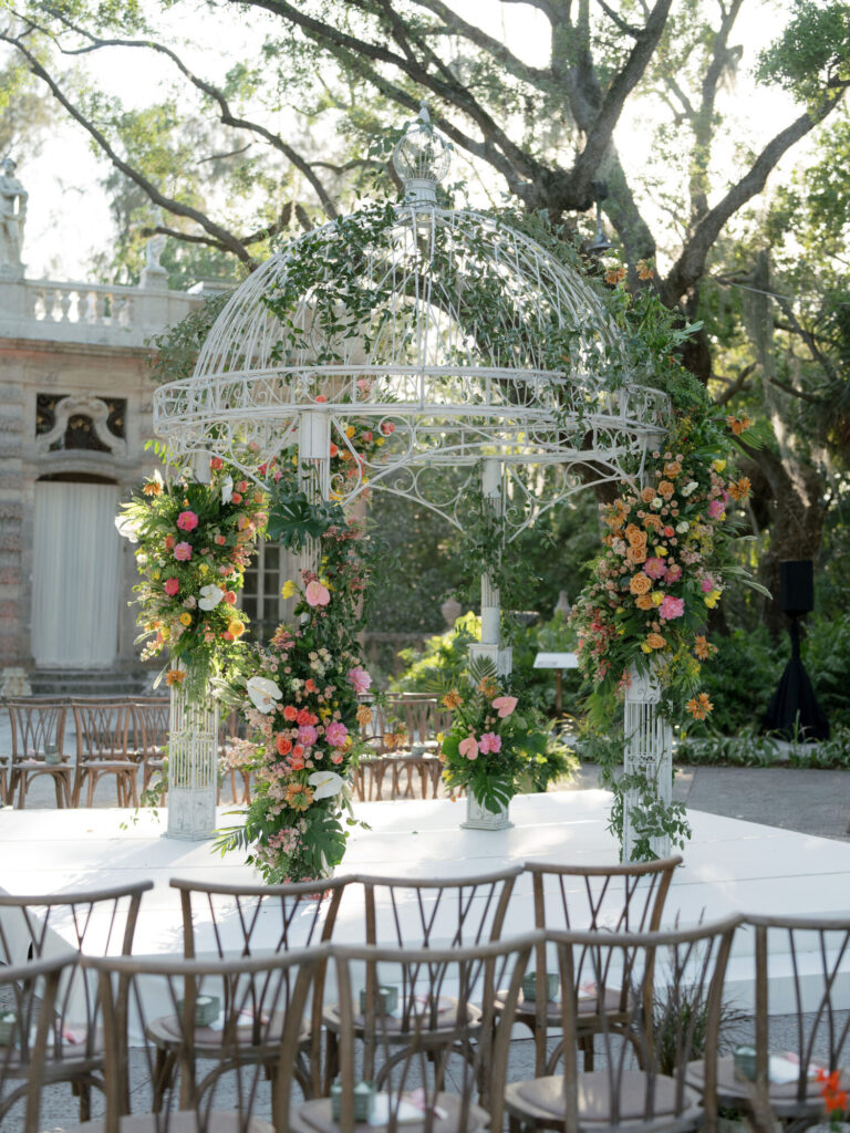 Outdoor Chicago wedding design ceremony beneath a floral-covered gazebo surrounded by mature trees event design Rishi Patel