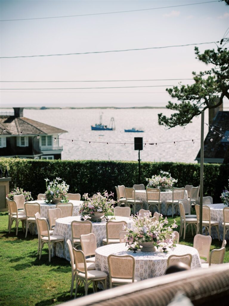 Outdoor waterfront wedding design reception with neutral seating and floral centerpieces wedding designer Rishi Patel