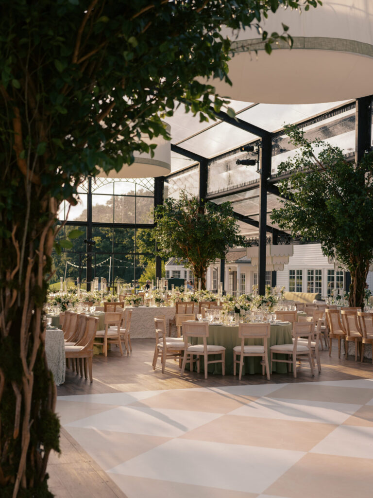 Chicago suburbs greenhouse wedding design reception with trees, neutral seating and glass walls wedding planning Rishi the Designer