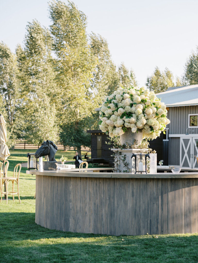 Chicago wedding design outdoor wedding bar with large white floral arrangement and garden setting event design and production company HMR Designs