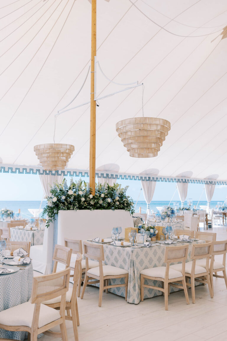Wedding Design tented reception with neutral seating, hanging chandeliers and soft blue accents event production HMR Designs
