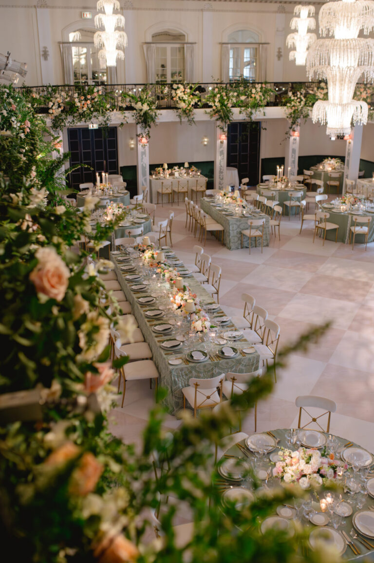 Chicago wedding designer elegant wedding reception with long tables, chandeliers and lush greenery design and production company HMR Designs