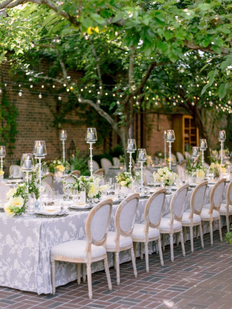 Chicago wedding designer outdoor wedding reception with white floral centerpieces and candlelight Chicago planner Rishi Patel