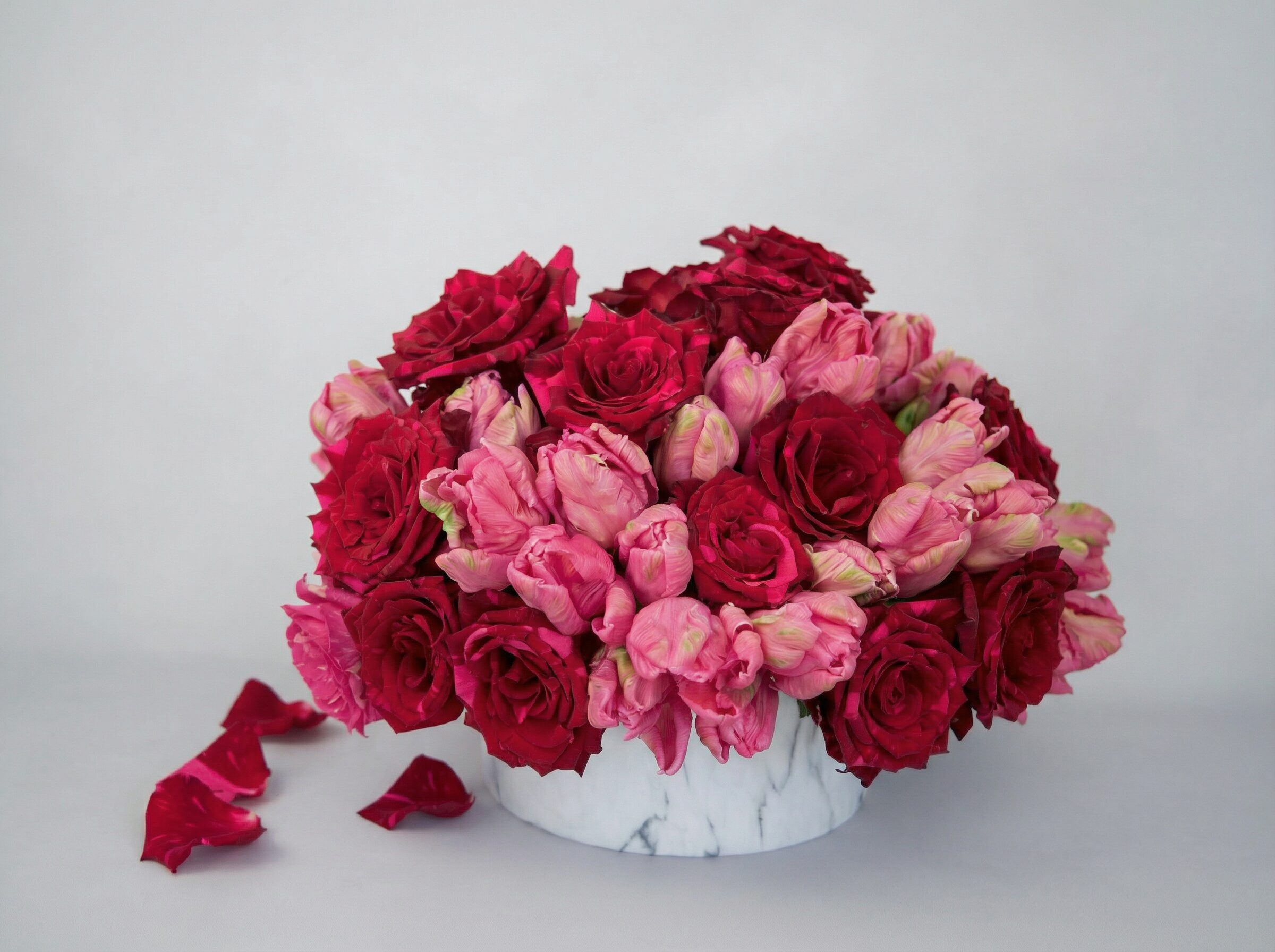 Valentine’s Day rose and tulip arrangement in a white marble vase