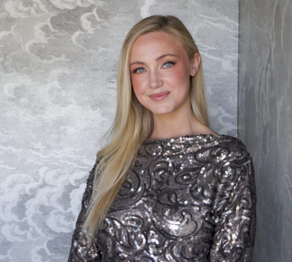 Bergen Darby, Event Designer at HMR Designs, smiling in a sequined outfit