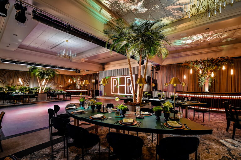 Chicago suburbs bar mitzvah design featuring tropical greenery, custom signage and an immersive dining setting by HMR Designs