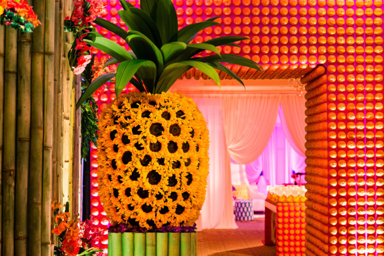 Chicago suburbs bat mitzvah design featuring a custom pineapple installation and colorful patterned entrance by event design and production company HMR Designs