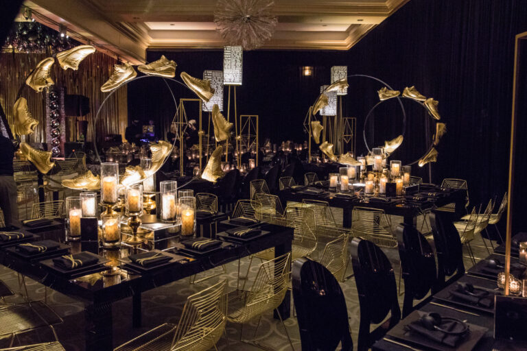 Chicago bar mitzvah design featuring candlelit tables, dark floral arrangements and dramatic gold accents by HMR Designs