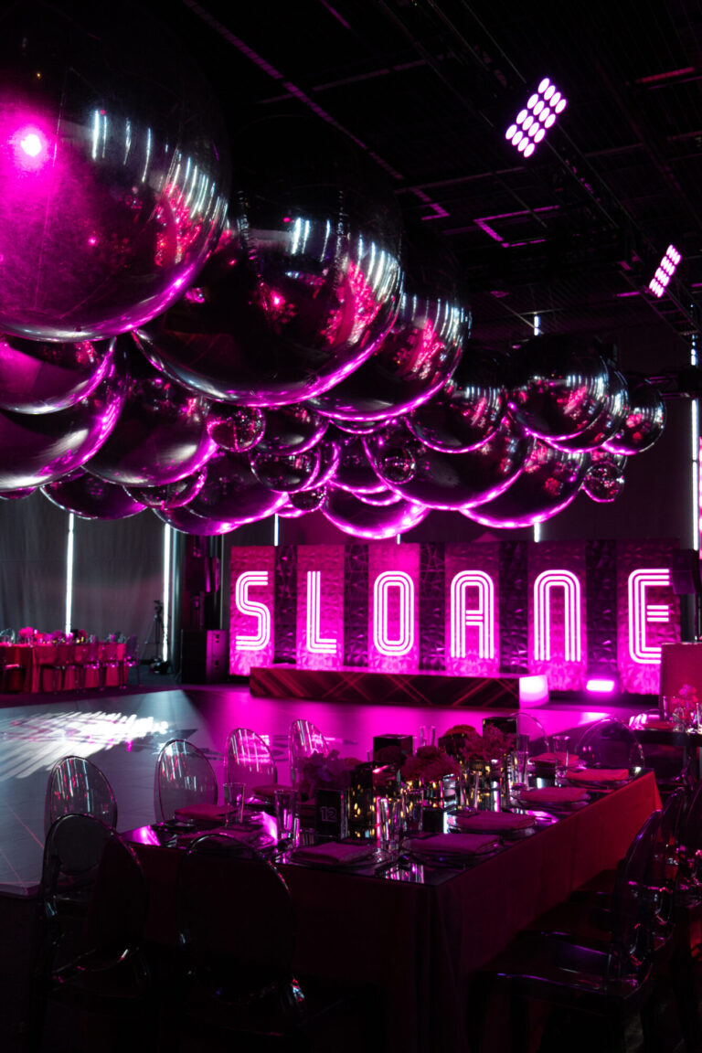 Chicago bat mitzvah design featuring a neon Sloane sign, suspended décor and pink lighting by event design company HMR Designs