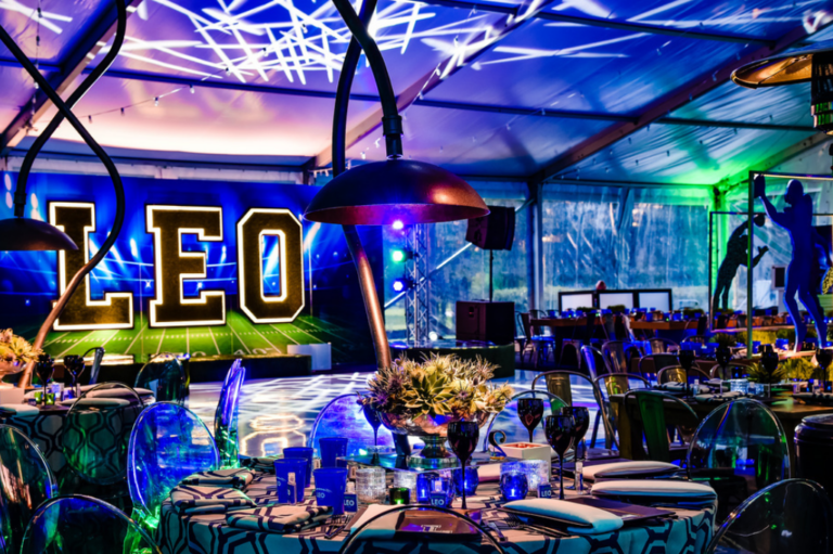 Chicago suburbs bar mitzvah design featuring a custom Leo sign, basketball details and blue lighting by event design company HMR Designs