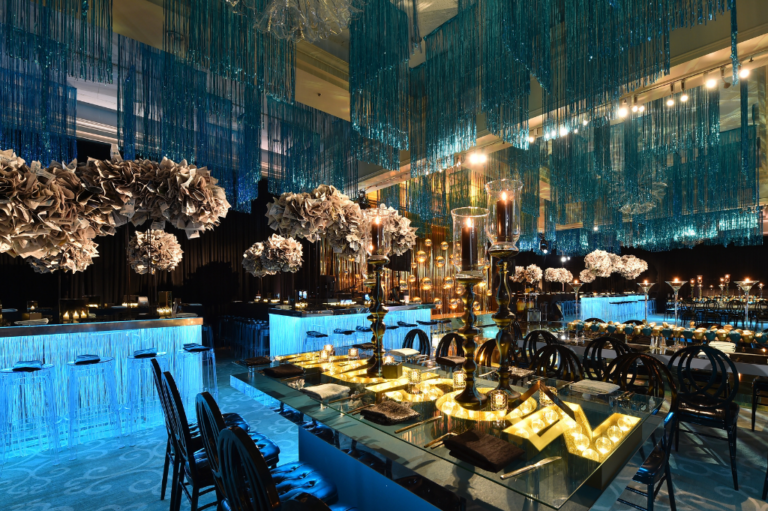 Chicago bat mitzvah design featuring a candlelit dinner with cascading greenery and white floral arrangements by event design company HMR Designs
