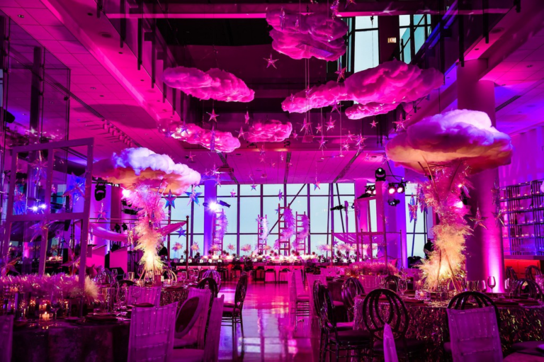 Chicago suburbs bat mitzvah design featuring suspended umbrellas, vivid pink lighting and whimsical décor by event design company HMR Designs