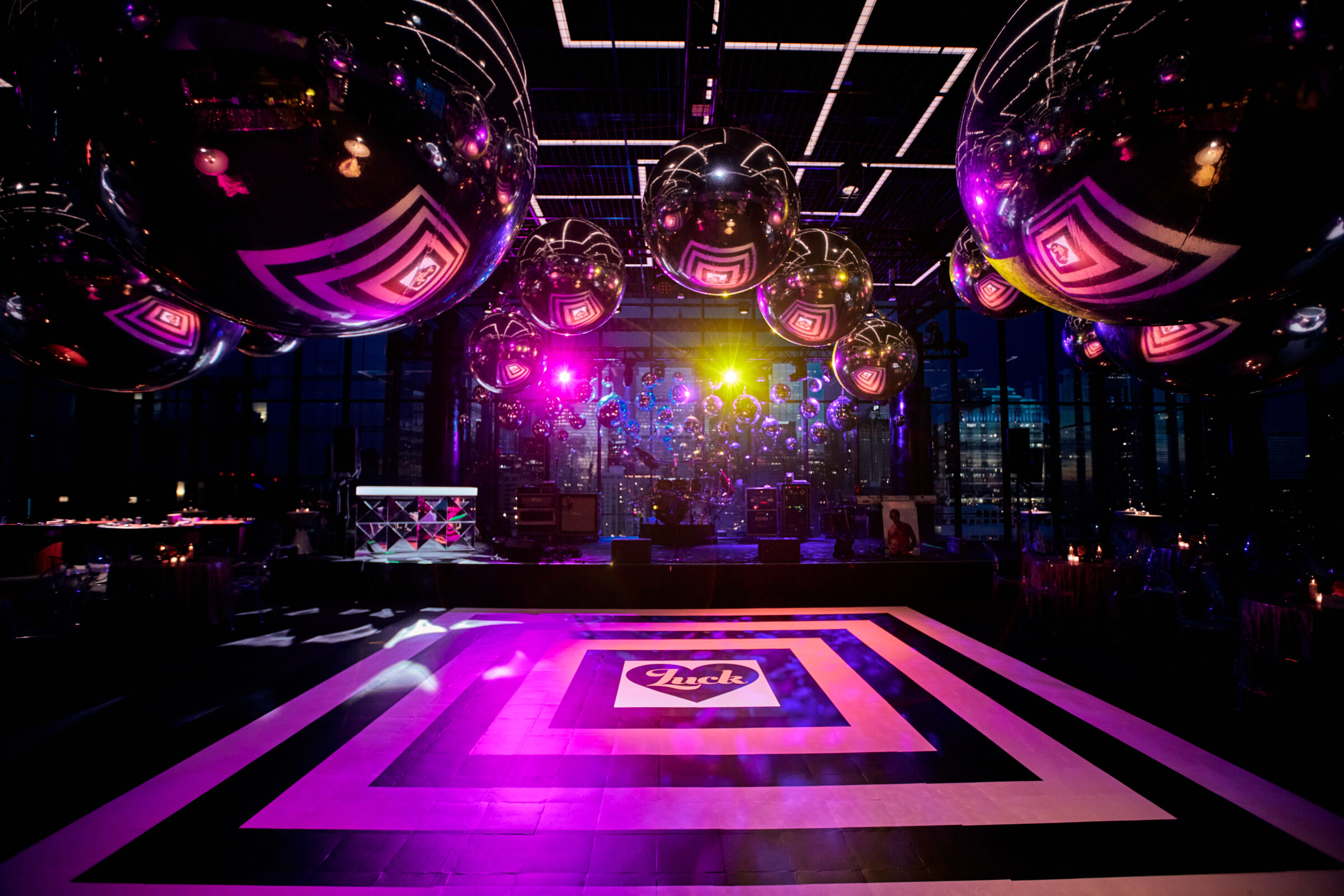 Colorful event dance floor with geometric graphics, disco balls and dramatic lighting